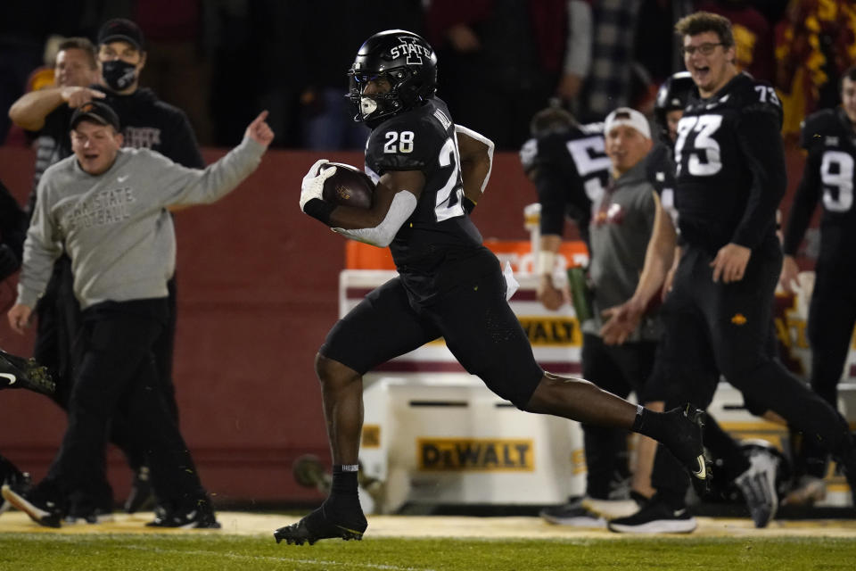 Iowa State running back Breece Hall (28) scores on an 80-yard touchdown run during the second half an NCAA college football game against TCU, Friday, Nov. 26, 2021, in Ames, Iowa. Iowa State won 48-14. (AP Photo/Charlie Neibergall)