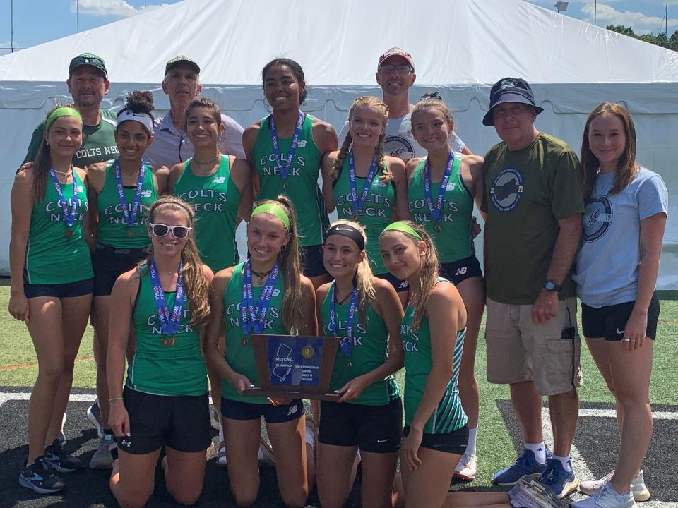 The Colts Neck girls track team with the Central Group 3 trophy