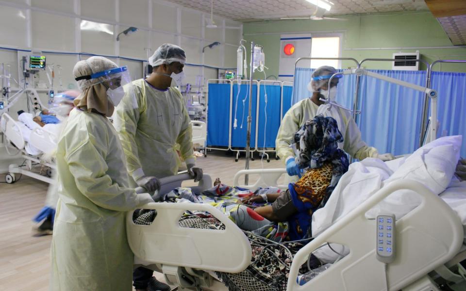 Doctors attend to a Covid-19 patient at a quarantine centre run by the International aid group Medecins Sans Frontieres in Aden - Reuters