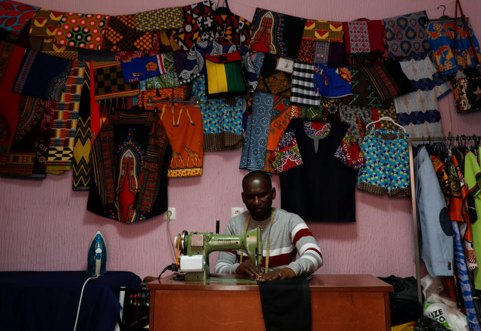 Idrissa Mane, 44, works at his sewing workshop in Cova da Moura 