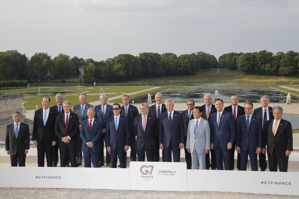 From left, Bank of Japan governor Haruhiko Kuroda, World Bank President David Malpass, Eurogroup President Mario Centeno, British Chancellor of the Exchequer Philip Hammond, Bank of Canada Governor Stephen Poloz, German Finance Minister Olaf Scholz, Federal Reserve Chair Jerome Powell, US Treasury Secretary Steve Mnuchin, Bank of England Governor Mark Carney, Bank of France Governor Francois Villeroy de Galhau, European Commissioner for Economic and Financial Affairs Pierre Moscovici, French Finance Minister Bruno Le Maire, Italian Economy and Finance Minister Giovanni Tria, Japan's Finance Minister Taro Aso, Organization for Economic Cooperation and Development (OECD) Secretary-General Angel Gurria, Canada's Finance Minister Bill Morneau, European Central Bank President Mario Draghi, German Bundesbank President Jens Weidmann, Bank of Italy Governor Ignazio Visco and International Monetary Fund (IMF) Deputy Managing Director David Lipton pose for a group photo at the G-7 Finance in Chantilly, north of Paris, on Wednesday, July 17, 2019. (AP Photo/Michel Euler)