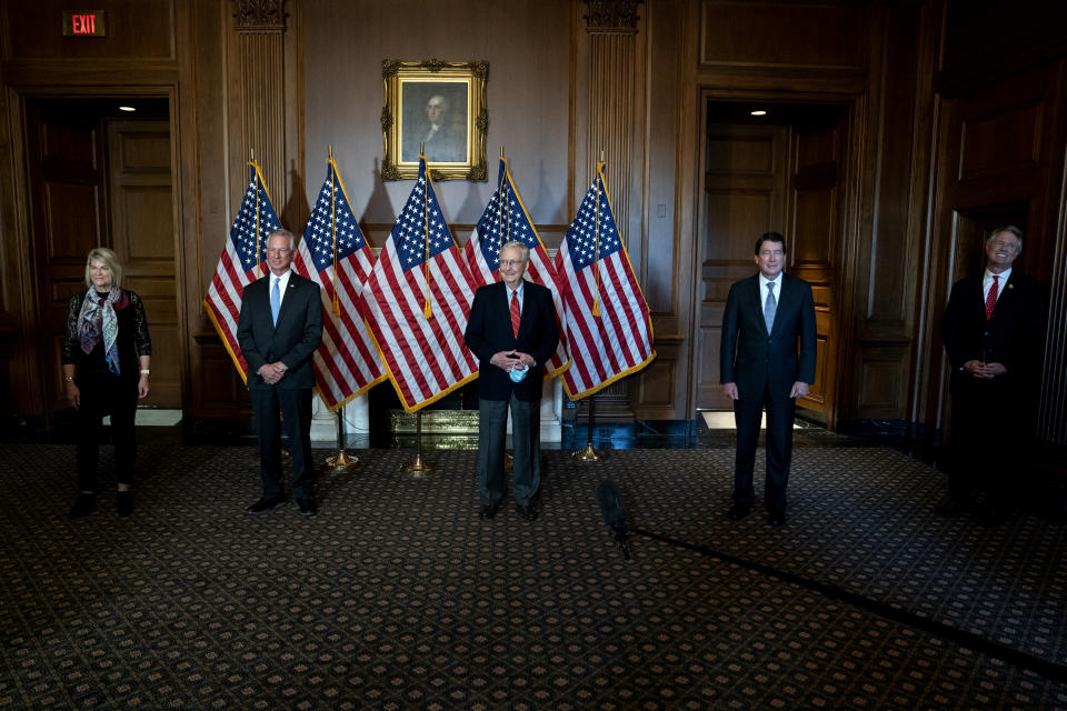 Senate Majority Leader Mitch McConnell of Ky., poses with newly elected Republican senators, from left, Sen.-elect Cynthia Lummis, R-Wyo., Sen.-elect Tommy Tuberville, R-Ala., Sen.-elect Bill Hagerty, R-Tenn., and Sen.-elect Roger Marshall, R-Kan., on Capitol Hill in Washington, Monday, Nov. 9, 2020. (Stefani Reynolds/Pool via AP)