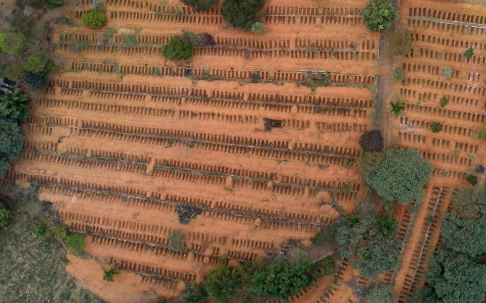 Newly dug, empty graves fill the Sao Luiz cemetery where Covid-19 victims will be buried in Sao Paulo, Brazil - AP