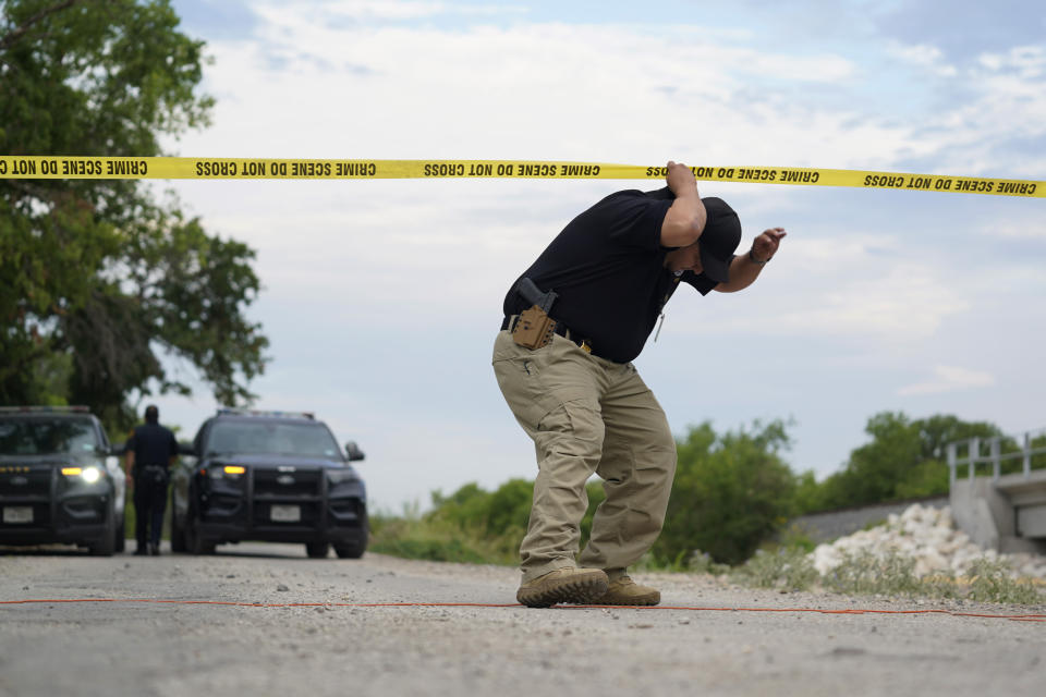 A U.S. Border Patrol agent leaves the scene where officials say dozens of people have been found dead and multiple others were taken to hospitals with heat-related illnesses after a semitrailer containing suspected migrants was found, Tuesday, June 28, 2022, in San Antonio. (AP Photo/Eric Gay)