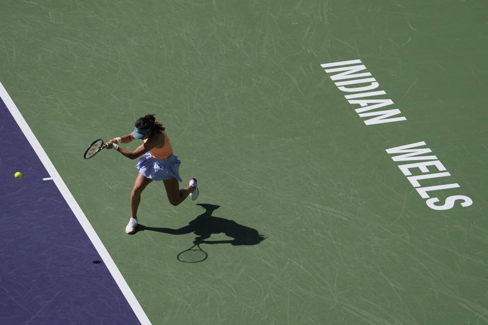 Emma Raducanu, of Britain, returns a shot to Danka Kovinic, of Montenegro,at the BNP Paribas Open tennis tournament Thursday, March 9, 2023, in Indian Wells, Calif. (AP Photo/Mark J. Terrill)