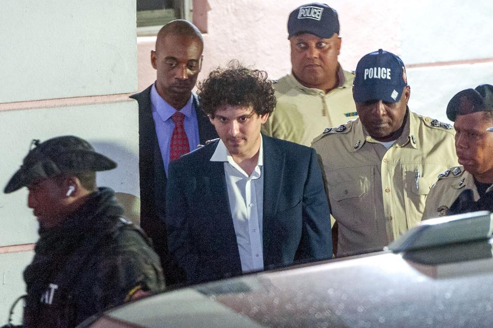 FTX founder Sam Bankman-Fried is led away handcuffed by officers of the Royal Bahamas Police Force in Nassau, Bahamas on Dec. 13, 2022. The disgraced cryptocurrency tycoon was hit with multiple criminal charges and is accused of committing one of the biggest financial frauds in US history.