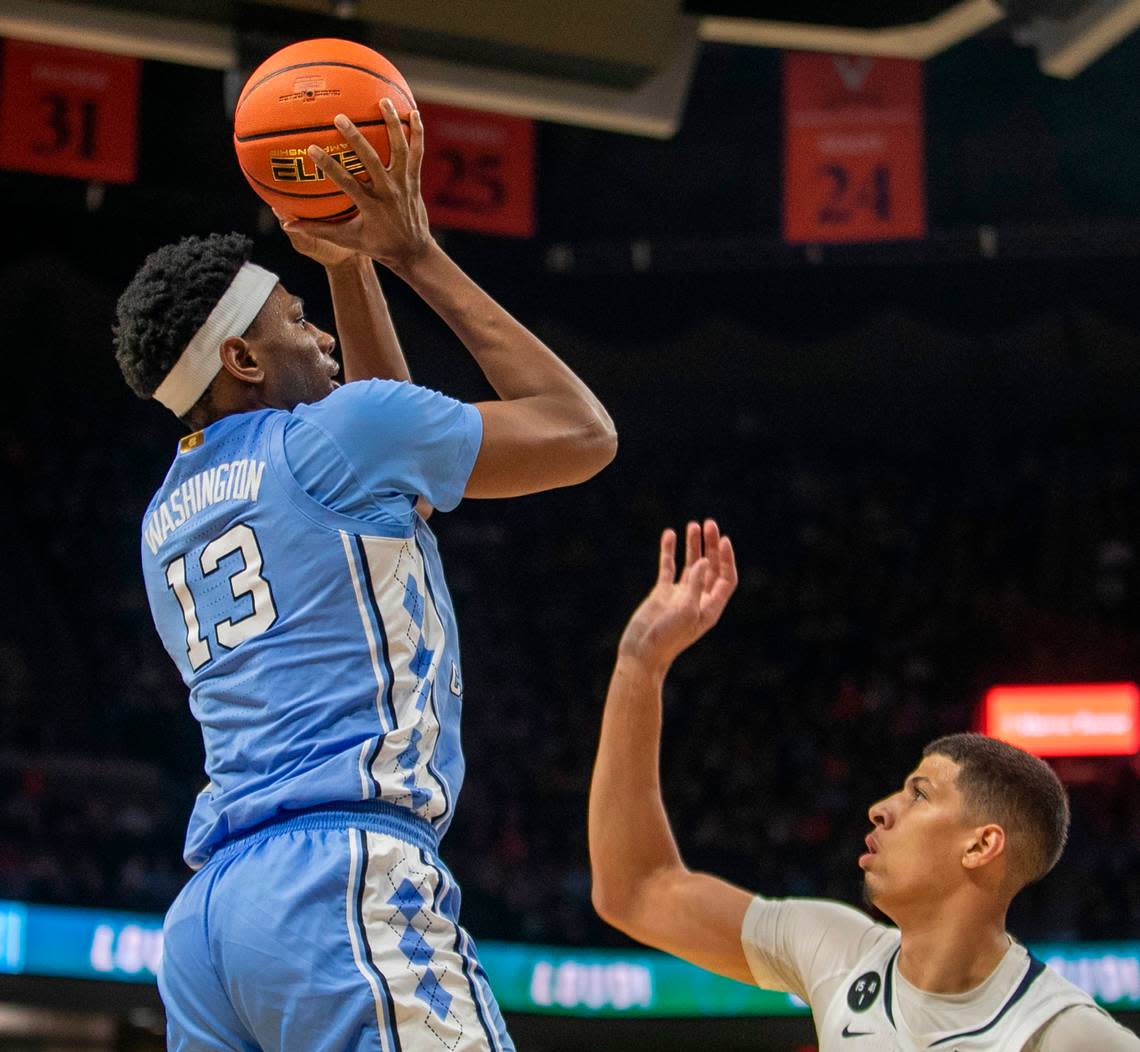 North Carolina’s Jalen Washington (13) puts up a shot against Virginia’s Kadin Shedrick (21) during the second half on Tuesday, January 10, 2023 at John Paul Jones Arena in Charlottesville, Va. Washington scored 13 points.