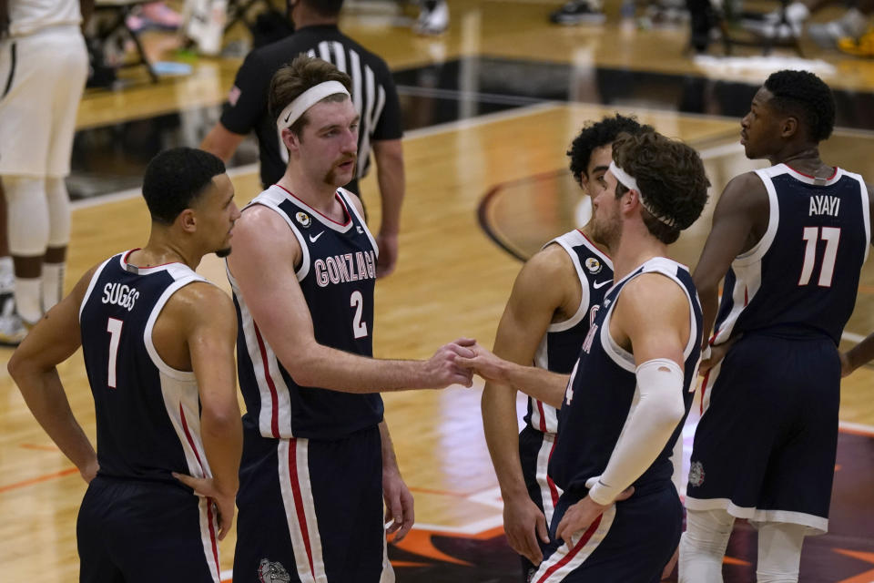 Gonzaga's Drew Timme, second from left, and Corey Kispert shake hands in the closing moments of Gonzaga's 76-58 win over Pacific in an NCAA college basketball game in Stockton, Calif., Thursday, Feb. 4, 2021. (AP Photo/Rich Pedroncelli)