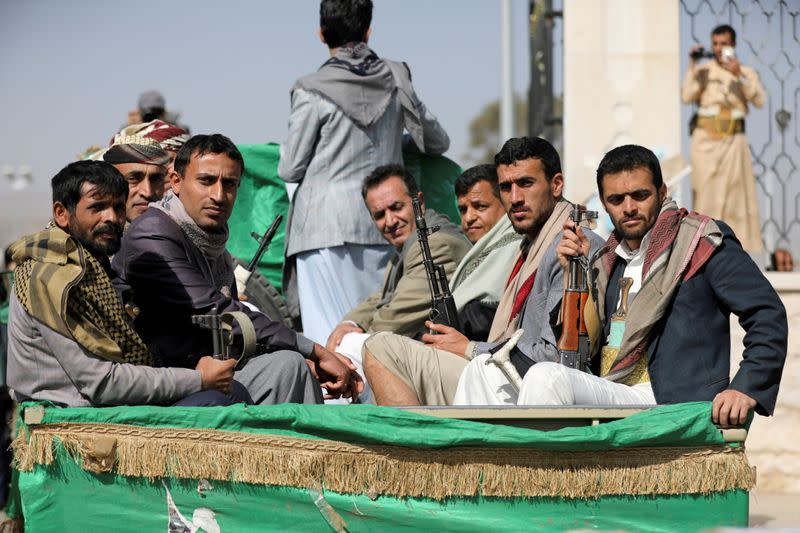 FILE PHOTO: Armed Houthi followers ride on the back of a truck after participating in a funeral of Houthi fighters killed in recent fighting against government forces in Yemen's oil-rich province of Marib, in Sanaa, Yemen