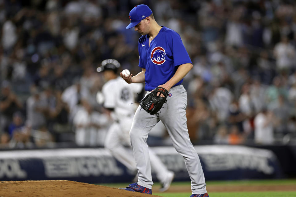 Chicago Cubs pitcher Matt Swarmer, foreground, looks at a new ball after giving up a home run to New York Yankees' Anthony Rizzo (48) during the fifth inning of a baseball game on Saturday, June 11, 2022, in New York. (AP Photo/Adam Hunger)
