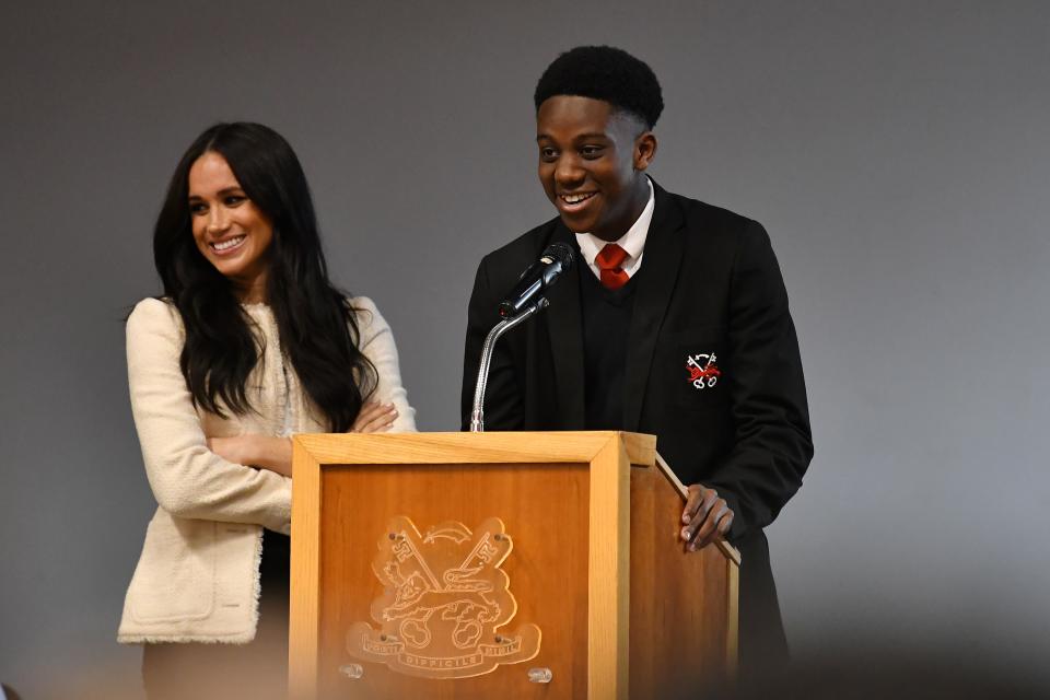 LONDON, ENGLAND - MARCH 06: Meghan, Duchess of Sussex smiles as the student Aker Okoye speaks during a special school assembly at the Robert Clack Upper School in Dagenham ahead of International Women’s Day (IWD) held on Sunday 8th March, on March 6, 2020 in London, England.   (Photo by Ben Stansall-WPA Pool/Getty Images)