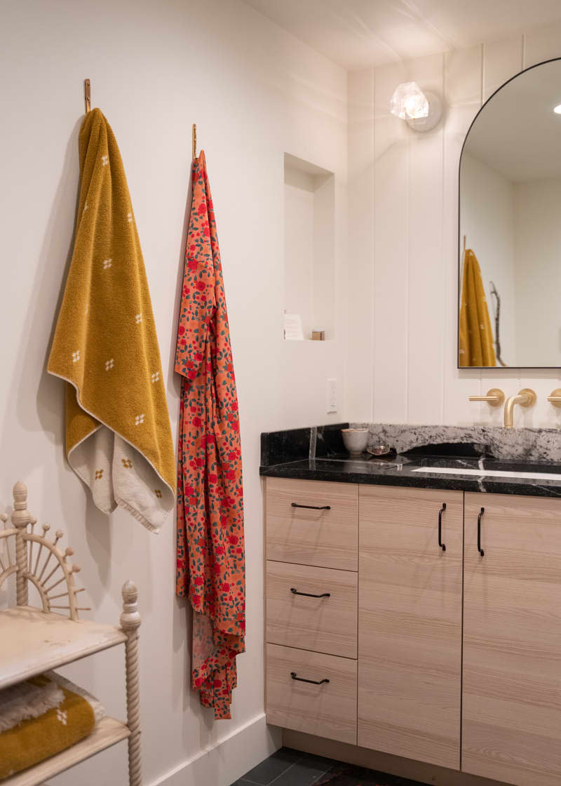 Colorful towels on bathroom hooks.