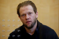 FILE PHOTO: Salafist preacher Sven Lau appears behind a bullet-proof window at a high-security courtroom in Duesseldorf, Germany April 25, 2017. REUTERS/Wolfgang Rattay/File Photo