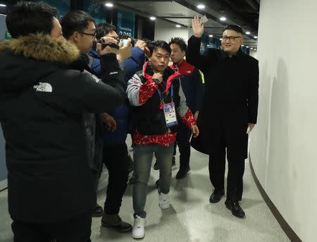 Ice Hockey – Pyeongchang 2018 Winter Olympics – Women Preliminary Round Match - Korea v Japan - Kwandong Hockey Centre, Gangneung, South Korea – February 14, 2018 - Kim Jong-un impersonator is escorted from the arena by security personnel. REUTERS/Lucy Nicholson