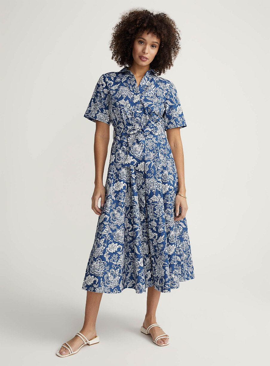 woman with afro wearing blue floral Bright bouquet shirtdress (photo via Simons)