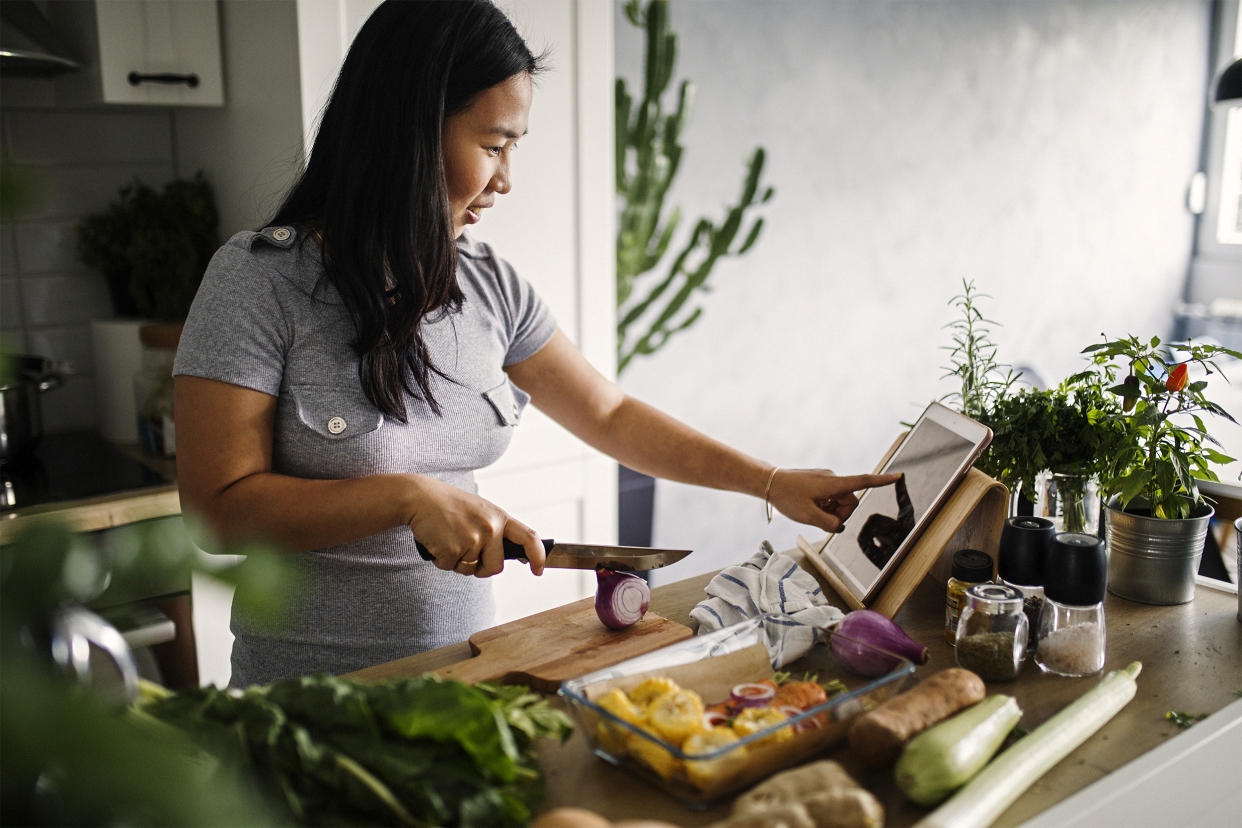 woman cooking in the kitchen using her tablet