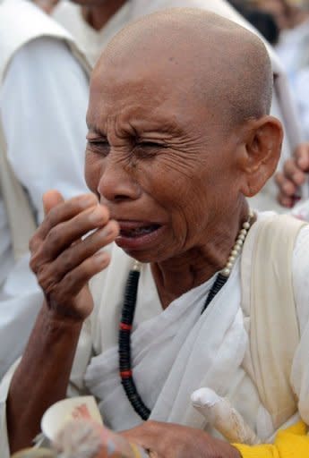 A Cambodian nun sobs as she mourns the death of former monarch Norodom Sihanouk during a rally outside the Royal Palace in Phnom Penh