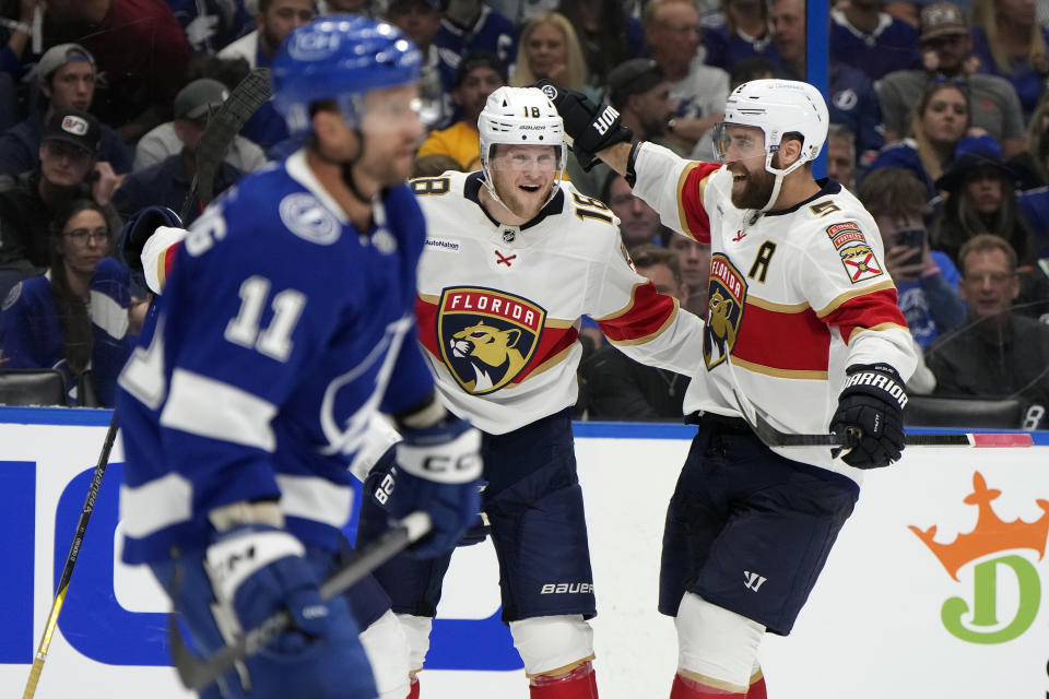Florida Panthers center Steven Lorentz (18) celebrates his goal against the Tampa Bay Lightning with defenseman Aaron Ekblad (5) during the third period in Game 3 of an NHL hockey Stanley Cup first-round playoff series, Thursday, April 25, 2024, in Tampa, Fla. (AP Photo/Chris O'Meara)