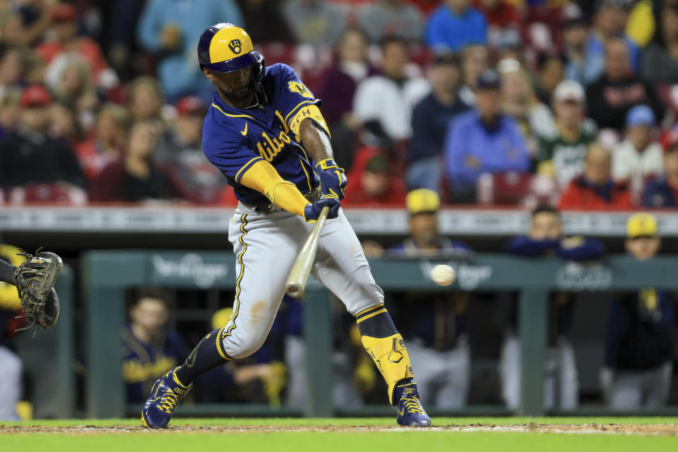 Milwaukee Brewers' Andrew McCutchen hits an RBI-force out during the fifth inning of a baseball game against the Cincinnati Reds in Cincinnati, Friday, Sept. 23, 2022. (AP Photo/Aaron Doster)
