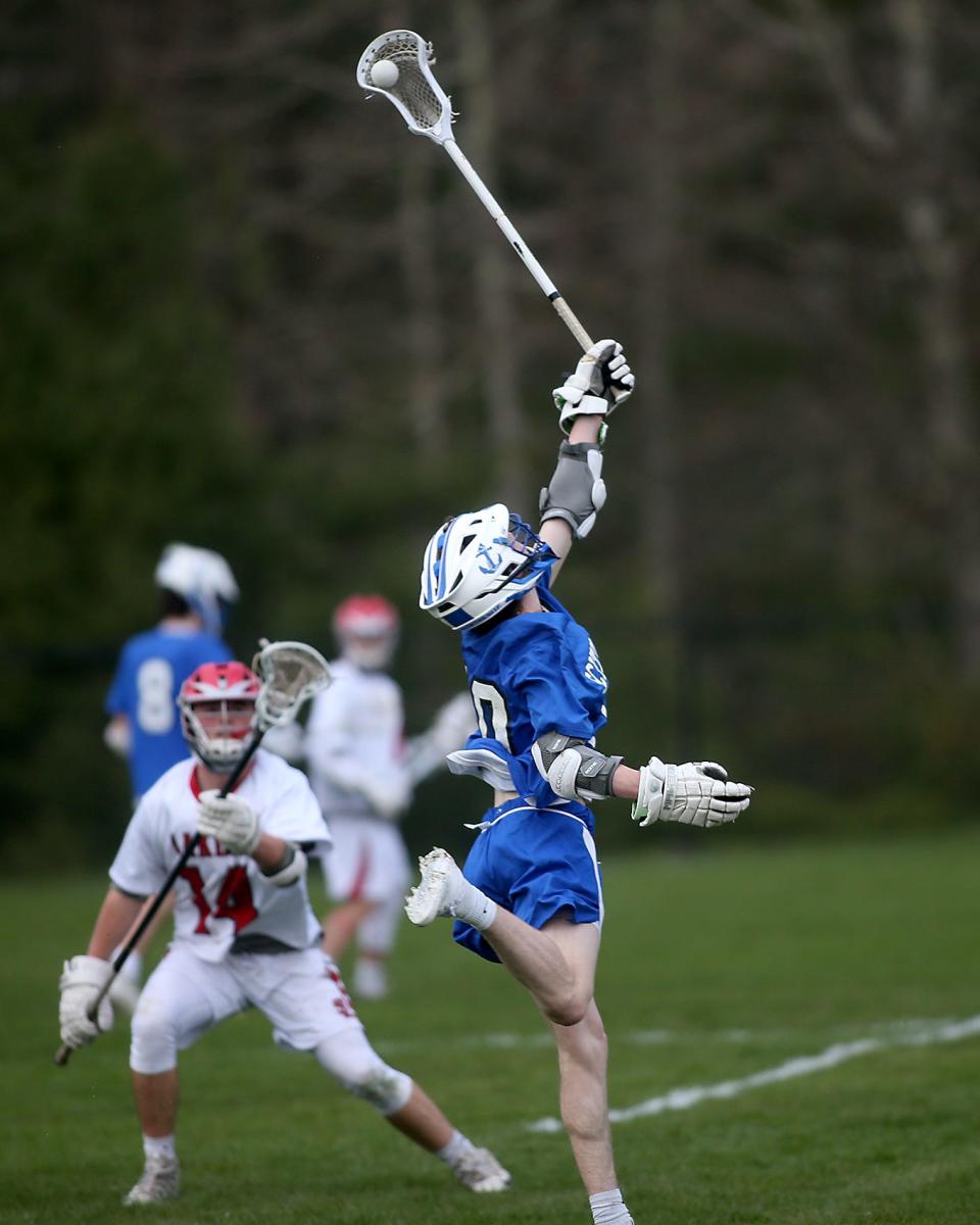 Scituate's Owen Hofford leaps up to knock down the pass during fourth quarter action of their game against Silver Lake at Silver Lake Regional High School on Tuesday, April 26, 2022. 