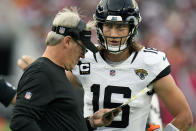 Jacksonville Jaguars head coach Doug Pederson meets with quarterback Trevor Lawrence (16) on the sideline during the first half of an NFL football game against the Tampa Bay Buccaneers, Sunday, Dec. 24, 2023, in Tampa, Fla. (AP Photo/Chris O'Meara)