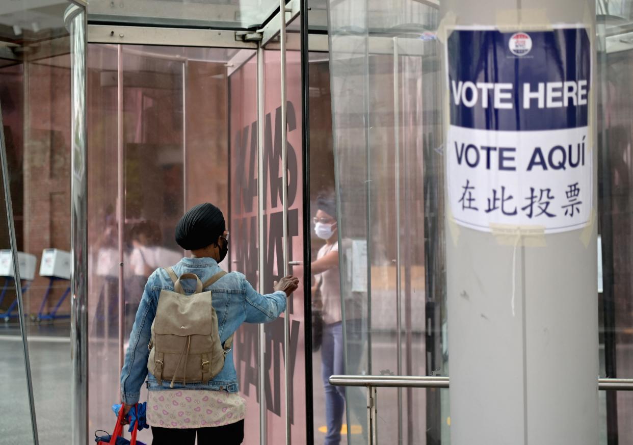 Residents arrive to vote during the New York City mayoral primary election at the Brooklyn Museum polling station on June 22, 2021 in New York City.