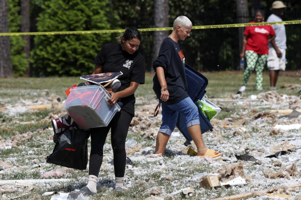 Friends and family help gather belongings of a house that sustained an explosion in Mooresville, N.C., Tuesday, Aug. 22, 2023. (Melissa Melvin-Rodriguez/The Charlotte Observer via AP)