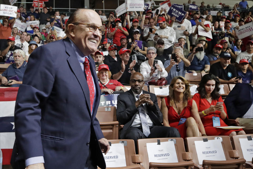 FILE - In this Aug. 15, 2019, file photo, former New York City Mayor Rudy Giuliani smiles as he arrives to President Donald Trump's campaign rally in Manchester, N.H. Federal prosecutors are planning to interview an executive with Ukraine’s state-owned gas company as part of an ongoing probe into the business dealings of Giuliani and two of his Soviet-born business associates. (AP Photo/Elise Amendola, File)