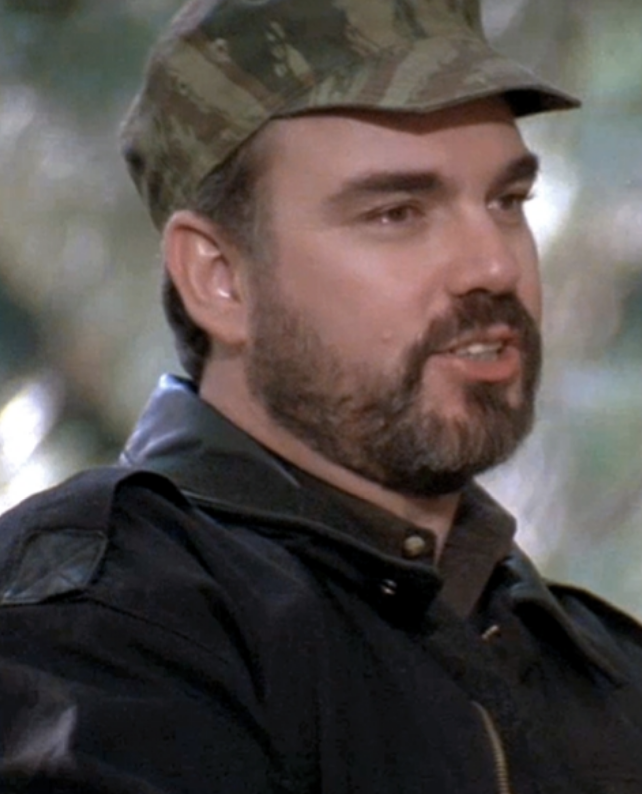 closeup of him in the film wearing a camo hat