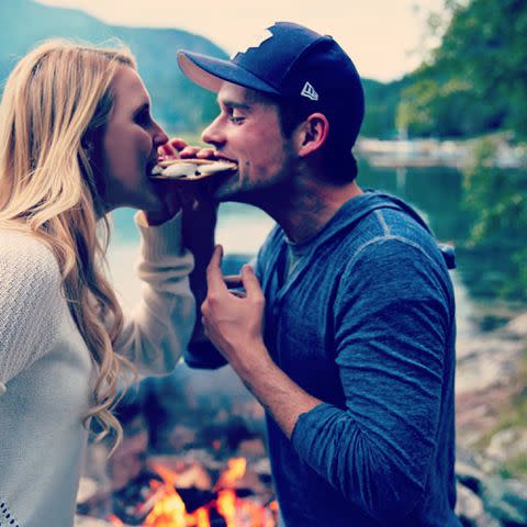 <p>Nila Meyers Instagram</p> Benjamin Hollingsworth and wife Nila Meyers eat a s'more together.