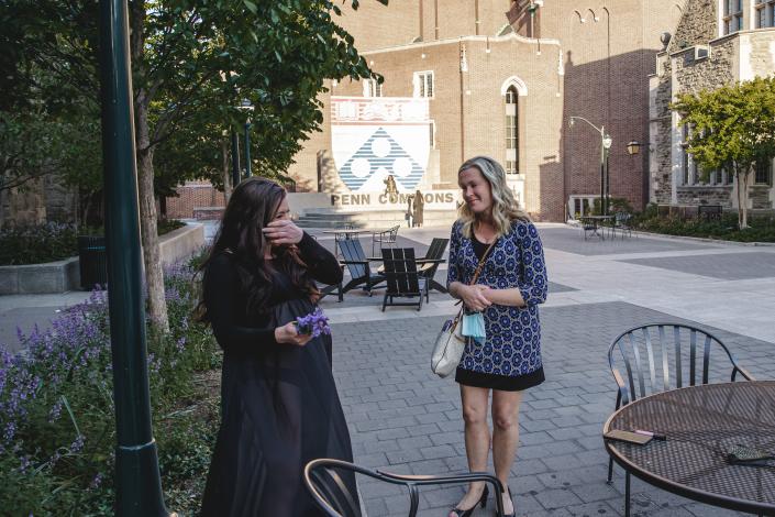 Chelsea Jovanovich, left, and Cheryl Cichonski-Urban meet for the first time during Jovanovich&#39;s maternity shoot, on May 16, 2021, outside Penn Commons on the University of Pennsylvania campus in Philadelphia.