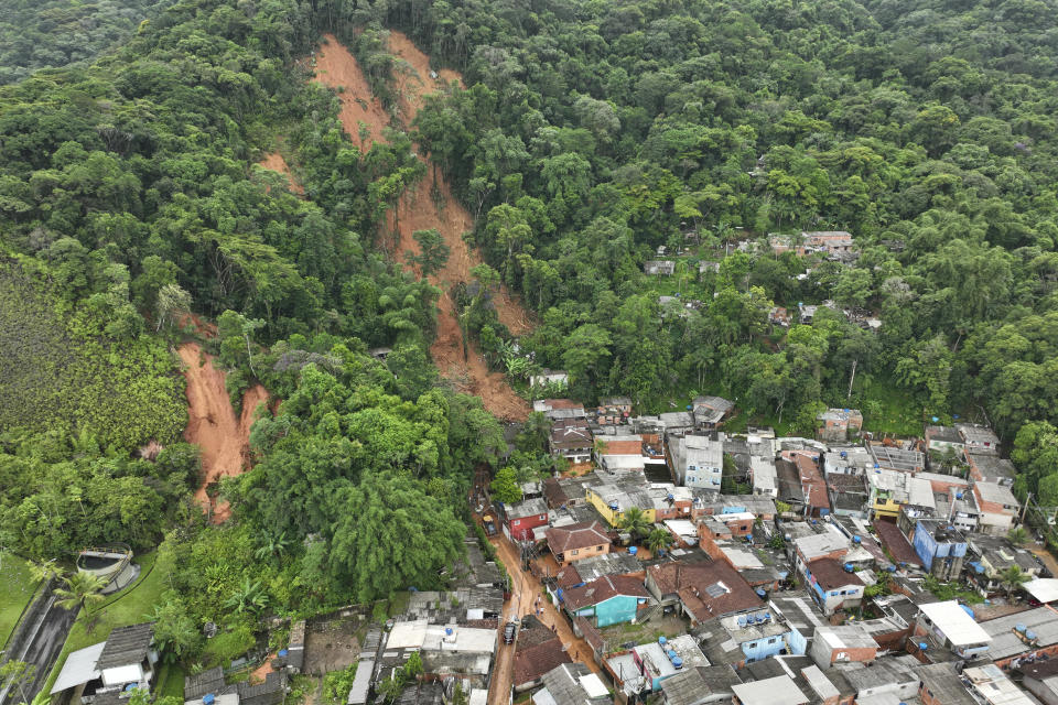 A hillside is exposed after flooding triggered deadly landslides near Juquehy beach in Sao Sebastiao, Brazil, Monday, Feb. 20, 2023. (AP Photo/Andre Penner)