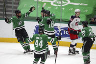 Dallas Stars Jamie Benn (14), Joel Hanley (44), Jason Dickinson (18) and Sami Vatanen (45) celebrate a second-period goal by right wing Denis Gurianov against the Columbus Blue Jackets during an NHL hockey game on Thursday, April 15, 2021, in Dallas. (AP Photo/Richard W. Rodriguez)