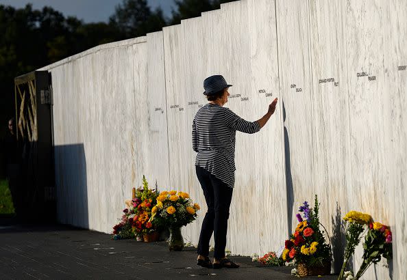 SHANKSVILLE, PENNSYLVANIA - SEPTEMBER 11: (EDITOR'S NOTE: Alternate crop.) A relative of one of the victims pays her respects at the Wall of Names before a ceremony commemorating the 22nd anniversary of the crash of Flight 93 during the September 11, 2001 terrorist attacks at the Flight 93 National Memorial on September 11, 2023 in Shanksville, Pennsylvania. The nation is marking the 22nd anniversary of the September 11 attacks, when the terrorist group al-Qaeda flew hijacked airplanes into the World Trade Center, Shanksville, PA and the Pentagon, killing nearly 3,000 people. (Photo by Jeff Swensen/Getty Images)