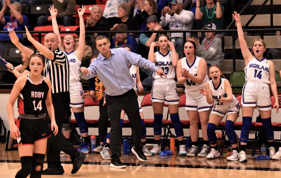 The Highland bench and coach Kyle Johnson respond to Taylor Allen's 3-point goal in the second half against Roby.