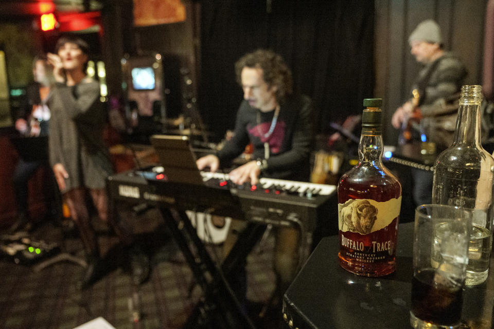 Musicians, Sara Niemietz, left, performs music of her album Superman with Linda Taylor, Léo Costa, Ed Roth, and Daniel Pearson at The Seven Grand as a bottle of Buffalo Trace bourbon is served at the whiskey bar downtown Los Angeles Tuesday, Feb. 28, 2023. The best bourbons are buttery, smooth and oaky, and a growing cult of aficionados is willing to pay an astonishing sum to score even a shot of these premium spirits. Some are even willing to bend or break laws (AP Photo/Damian Dovarganes)