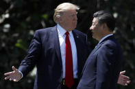 FILE - In this April 7, 2017, file photo, U.S. President Donald Trump gestures as he and Chinese President Xi Jinping walk together after their meetings at Mar-a-Lago, in Palm Beach, Fla. Trump started a tariff and trade war with China as concern grows over China’s challenge to U.S. technological might. (AP Photo/Alex Brandon, File)