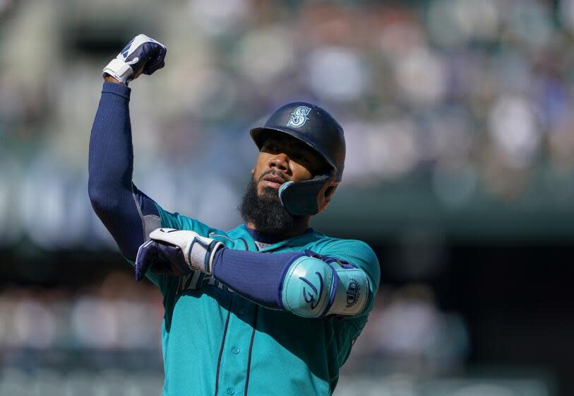 Seattle Mariners' Teoscar Hernandez gestures to the dugout after hitting an RBI single against the Los Angeles Angels during the fifth inning of a baseball game Wednesday, Sept. 13, 2023, in Seattle. (AP Photo/Lindsey Wasson)