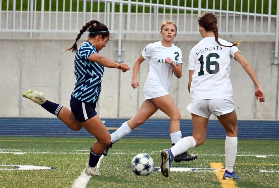 Petoskey's Annika Gandhi takes a shot through a pair of Alpena players during the first half of Thursday's action.