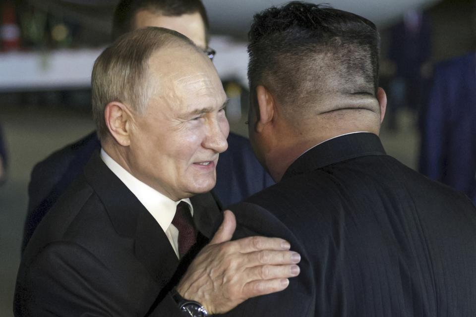 Russian President Vladimir Putin, left, and North Korea's leader Kim Jong Un greet each other during their meeting at the Pyongyang Sunan International Airport outside Pyongyang, North Korea, on Tuesday, June 18, 2024. (Gavriil Grigorov, Sputnik, Kremlin Pool Photo via AP)