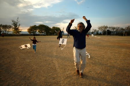 Mexican graphic artist Toledo and children fly kites, with pictures of missing students of Ayotzinapa Teacher Training College 'Raul Isidro Burgos', at Arts Center of San Miguel Etla, on outskirts of Oaxaca