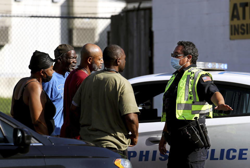 Memphis Police Department officers talk to nearby residents after a deadly shooting at a nearby post office Tuesday, Oct. 12, 2021 in the Orange Mound neighborhood of Memphis, Tenn. Police investigated a shooting Tuesday at a post office in an historic neighborhood of Memphis, Tennessee, the third high-profile shooting in the region in weeks.(Patrick Lantrip/Daily Memphian via AP)