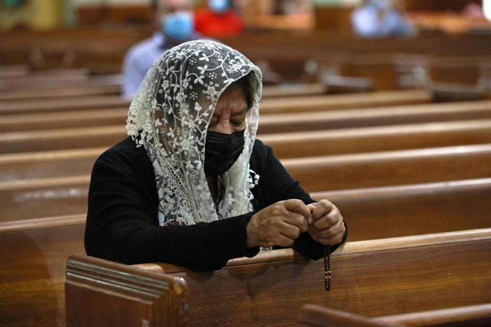 Sonia Rivas prays during Sunday Mass at St. Joseph’s Catholic Church in Miami Beach on June 27, 2021. Some of the church’s parishioners were among the missing after the condo collapse in nearby Surfside on Thursday, June 24.