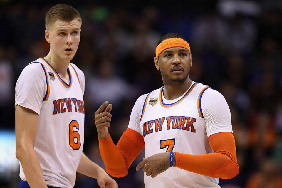 Kristaps Porzingis and Carmelo Anthony double-check which dudes they're supposed to be guarding. (Christian Petersen/Getty Images)