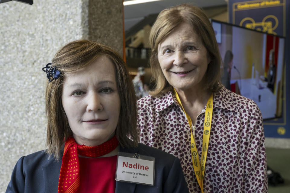 Nadia Thalmann, right, from the University of Geneva poses next to Humanoid robot Nadine during the ITU's AI for Good Global Summit in Geneva, Switzerland, Wednesday, July 5 2023. Artificial intelligence (AI) and robotics innovators and their high-tech creations will join diplomats, industry executives, academics, policy-makers, and UN partners in Geneva from July 6-7 for ITU's AI for Good Global Summit. (Martial Trezzini/Keystone via AP)