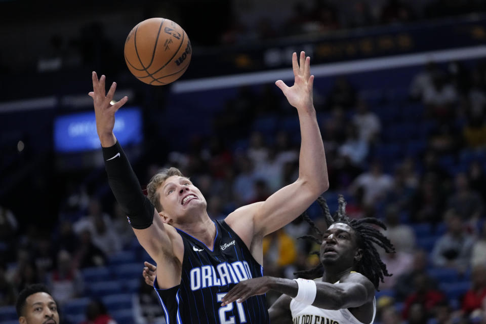 Orlando Magic center Moritz Wagner (21) battles for a rebound against New Orleans Pelicans guard Kira Lewis Jr. in the first half of an NBA preseason basketball game in New Orleans, Tuesday, Oct. 10, 2023. (AP Photo/Gerald Herbert)