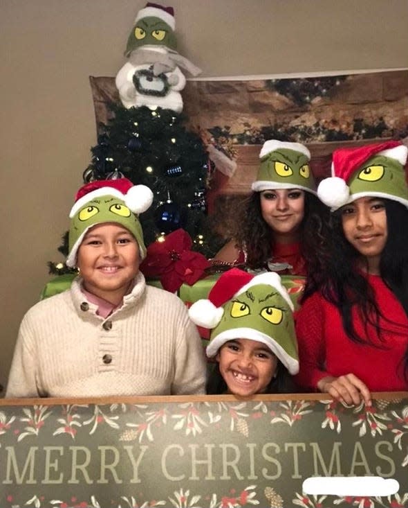 Araceli Zavala, 30 (back center), with kids Areli, 12 (right); Ashley, 6 (front middle); and Marcos, 9. Zavala overcame a troubled childhood by focusing on her education. As a single mom, she hopes to complete it one day. When recent family illnesses caused her to miss work and fall behind, Season of Sharing helped her catch up in time for Christmas.