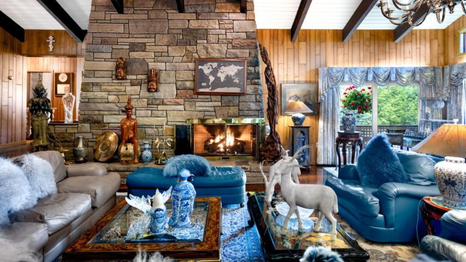 Main house living room with stone fireplace - Credit: Lifestyle Production Group Camilo Lopez From NUC