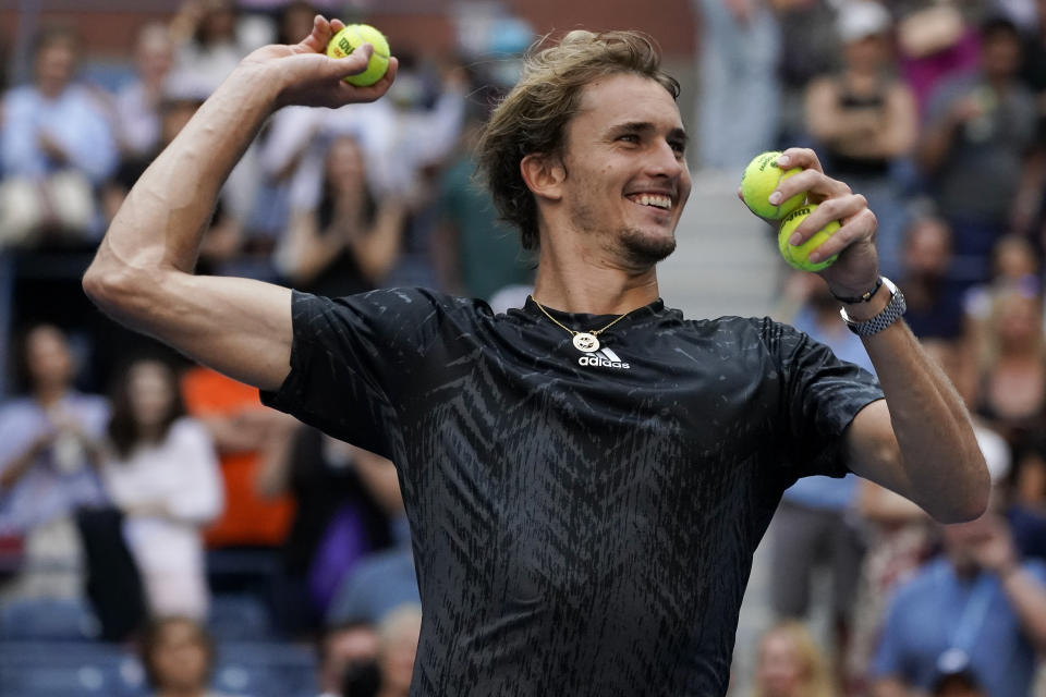 Alexander Zverev, of Germany, throws game balls to the crowd after defeating Lloyd Harris, of South Africa, during the quarterfinals of the US Open tennis championships, Wednesday, Sept. 8, 2021, in New York. (AP Photo/Elise Amendola)