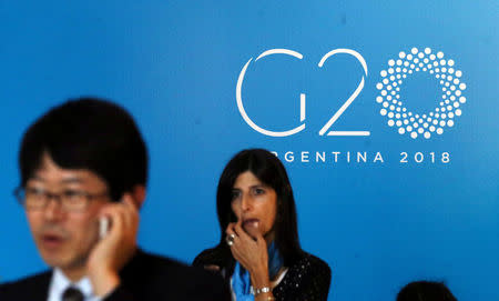 A man uses his mobile phone at the G20 Meeting of Finance Ministers in Buenos Aires, Argentina, March 19, 2018. REUTERS/Marcos Brindicci